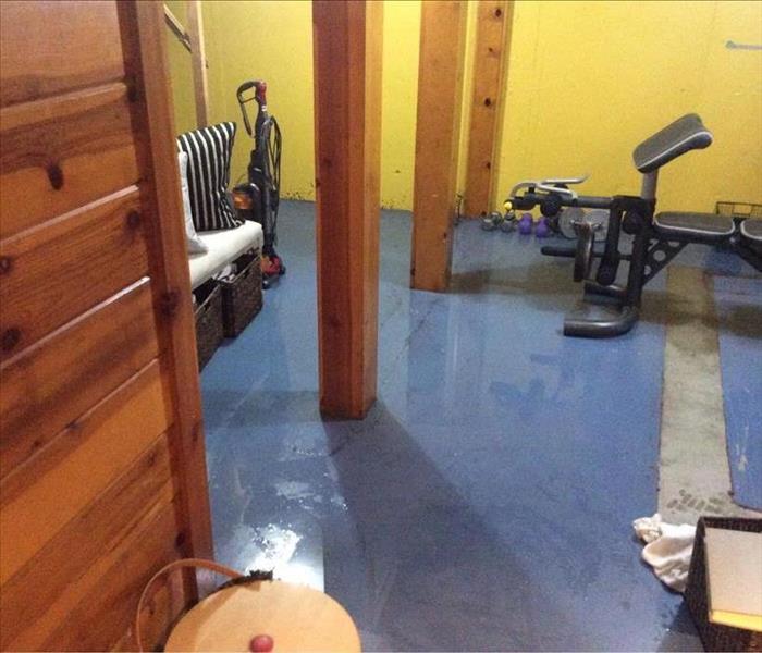flooded basement in home with workout machines  
