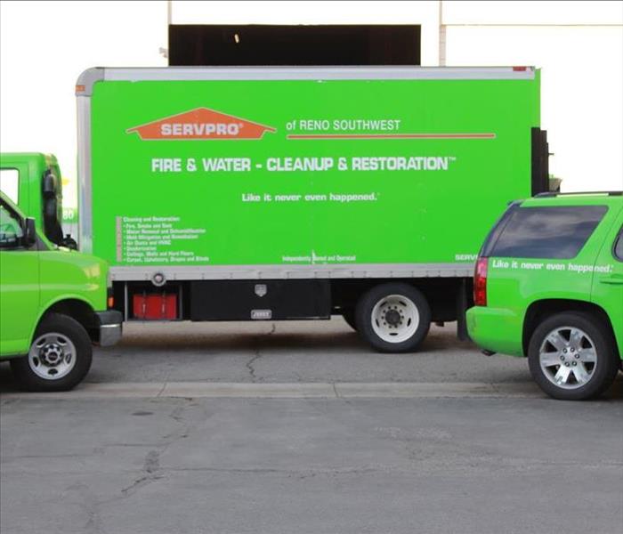 three SERVPRO vehicles parked in a parking lot 