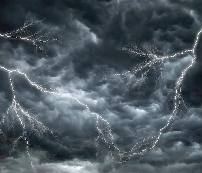 bright lightning striking in a dark vibrant cloudy sky 